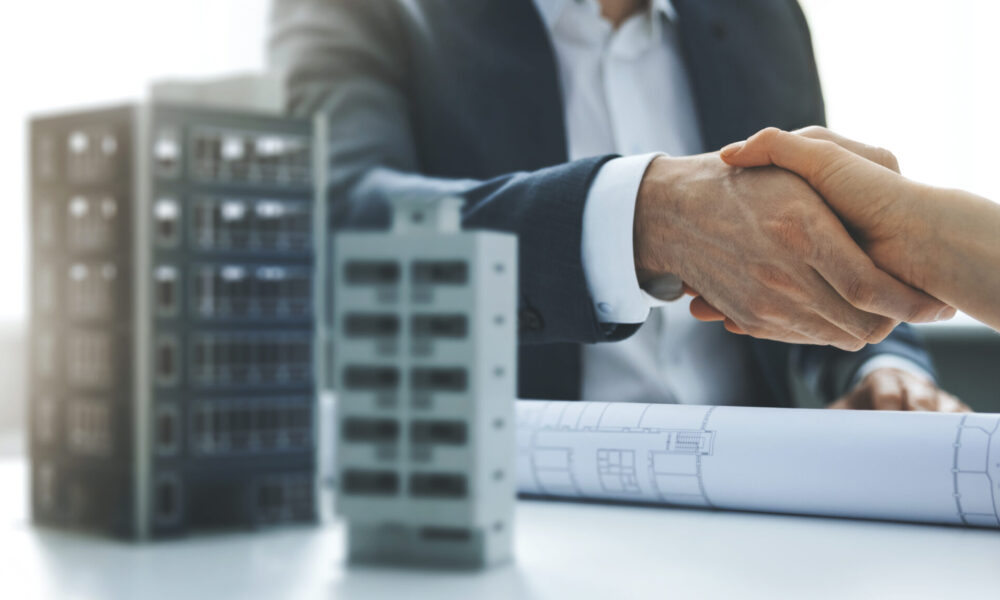 housing development and investment business - businessmen handsh housing development and investment business - businessmen handshake after agreement of apartment building construction. banner copy space
